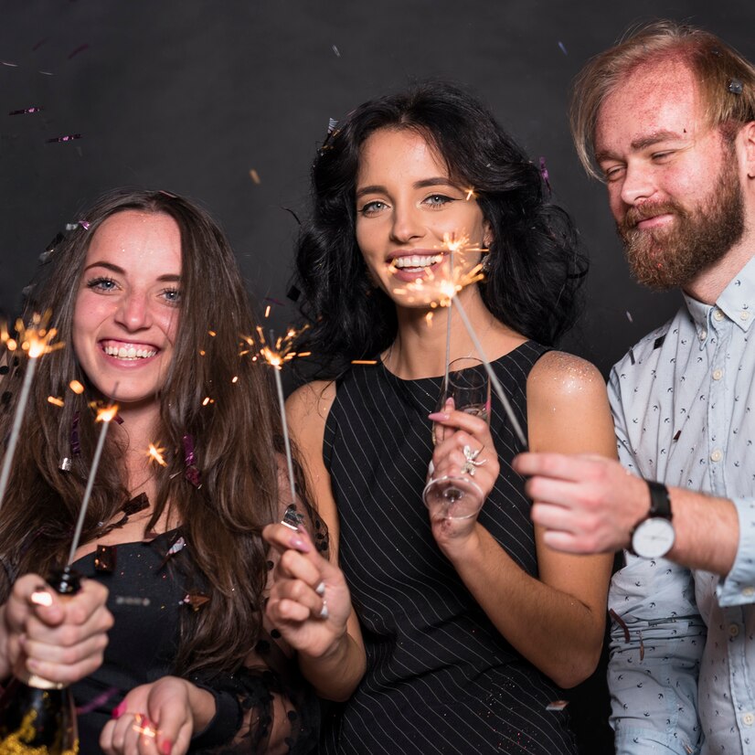 people-standing-with-sparklers-party_23-2147989913 Friends holding sparklers at a Luxe Photobooth event, capturing magical party memories in Gatineau and Ottawa